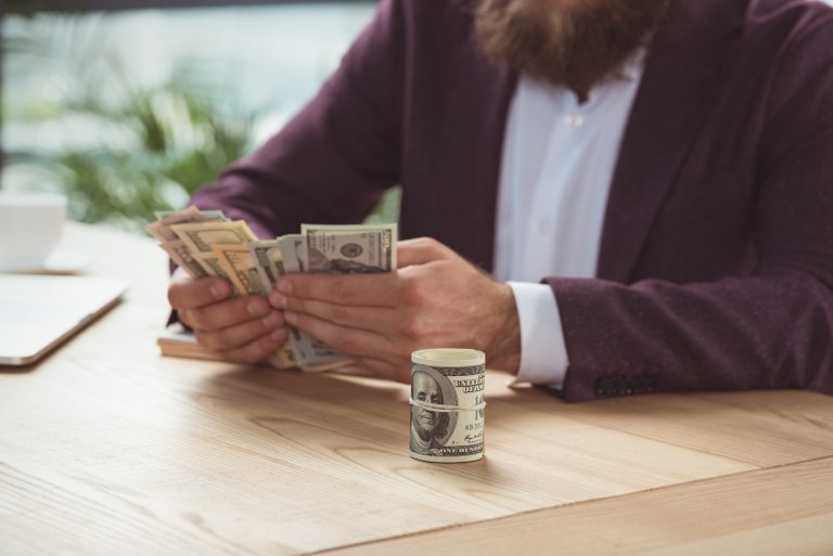 cropped view of businessman counting money, salary concept